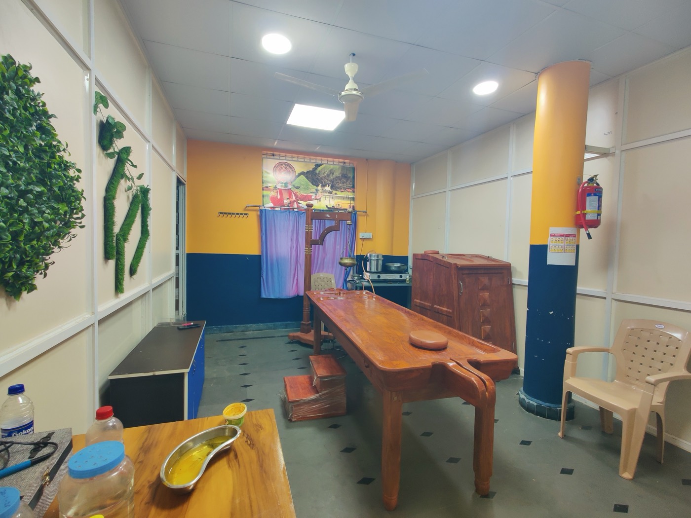 Panchakarma therapy room with traditional wooden droni table